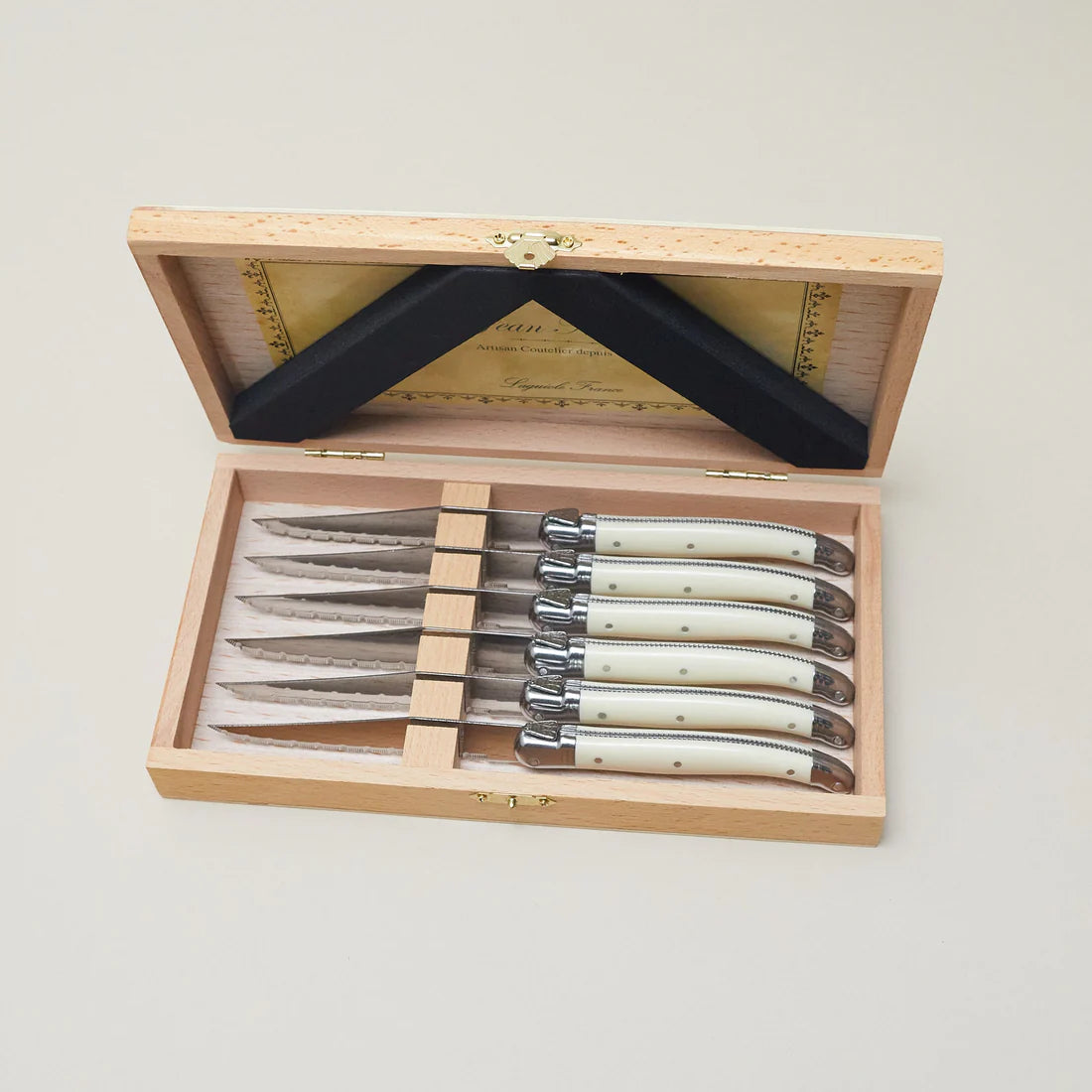 Laguiole six piece serrated steak knife set with platine ivory handles in a wooden presentation box
