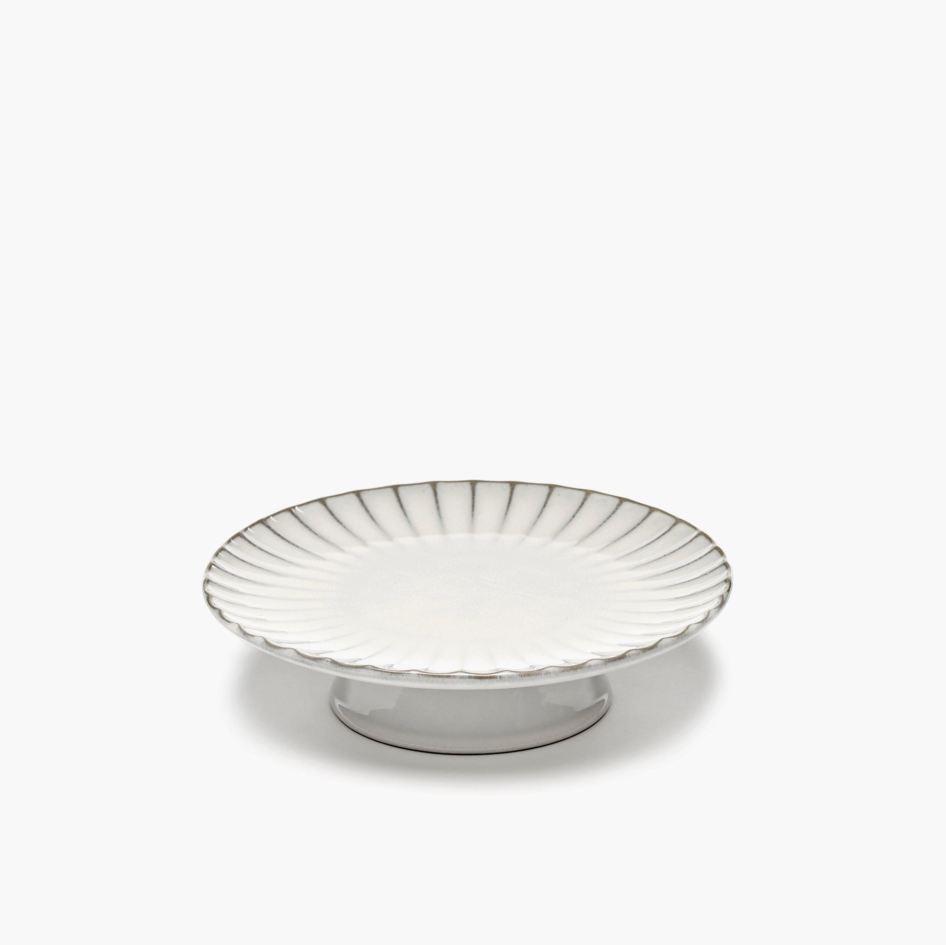 erax Inku collection white stoneware ceramic cake stand with a ribbed shell-shaped rim and a short pedestal base, isolated on a white background.