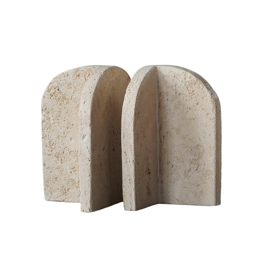 Beige travertine bookend pair with arched slab design, cream-tone stone, porous texture, and natural veining